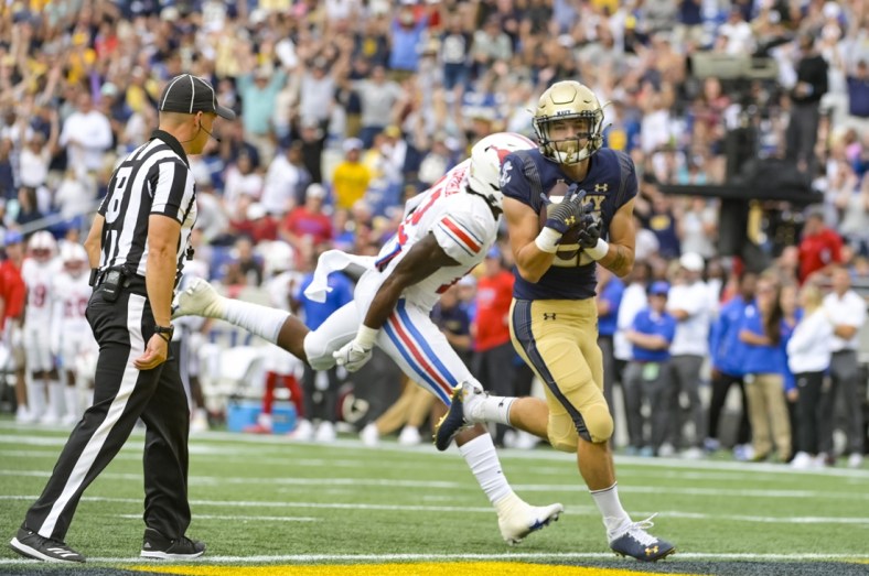 Oct 9, 2021; Annapolis, Maryland, USA;  Navy Midshipmen fullback Kai Puailoa-Rojas (21) catches a pass for a touch down as Southern Methodist Mustangs safety Isaiah Nwokobia (12) defends during the first half at Navy-Marine Corps Memorial Stadium. Mandatory Credit: Tommy Gilligan-USA TODAY Sports