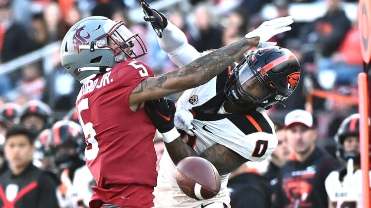 Oct 9, 2021; Pullman, Washington, USA; Washington State Cougars defensive back Derrick Langford (5) is called for pass interference on his play against Oregon State Beavers wide receiver Tre'Shaun Harrison (0) in the first half at Gesa Field at Martin Stadium. Mandatory Credit: James Snook-USA TODAY Sports