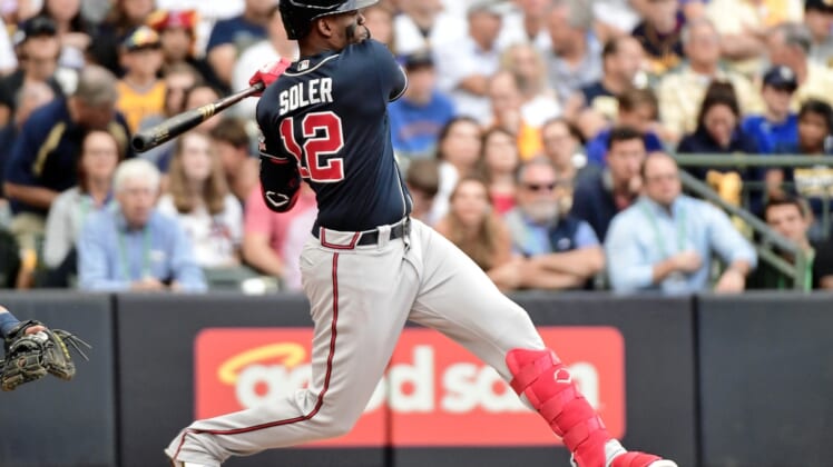 Oct 9, 2021; Milwaukee, Wisconsin, USA; Atlanta Braves right fielder Jorge Soler (12) hits a double against the Milwaukee Brewers during the second inning during game two of the 2021 NLDS at American Family Field. Mandatory Credit: Benny Sieu-USA TODAY Sports