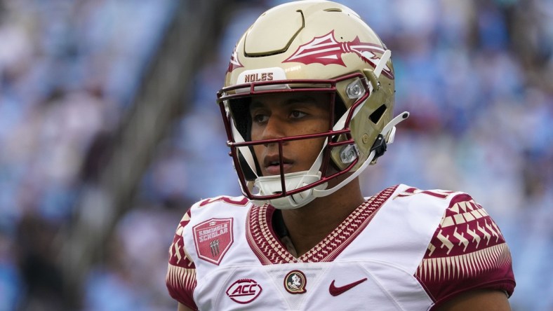 Oct 9, 2021; Chapel Hill, North Carolina, USA;  Florida State Seminoles quarterback Jordan Travis (13) looks on from the sidelines against the North Carolina Tar Heels at Kenan Memorial Stadium. Mandatory Credit: James Guillory-USA TODAY Sports