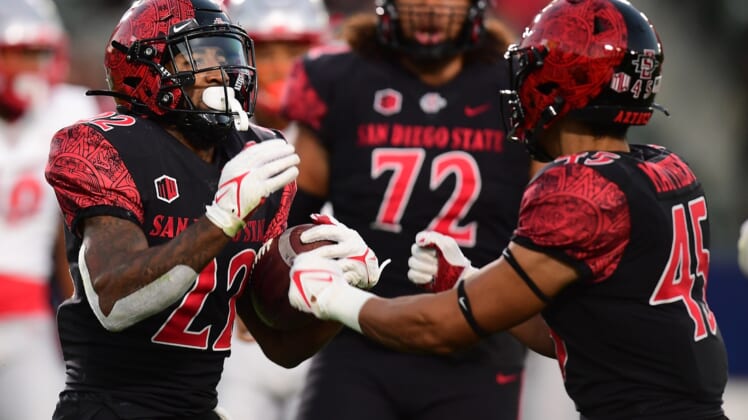 Oct 9, 2021; Carson, California, USA; San Diego State Aztecs running back Greg Bell (22) celebrates with wide receiver Jesse Matthews (45) his touchdown scored against the New Mexico Lobos during the first half at Dignity Health Sports Park. Mandatory Credit: Gary A. Vasquez-USA TODAY Sports