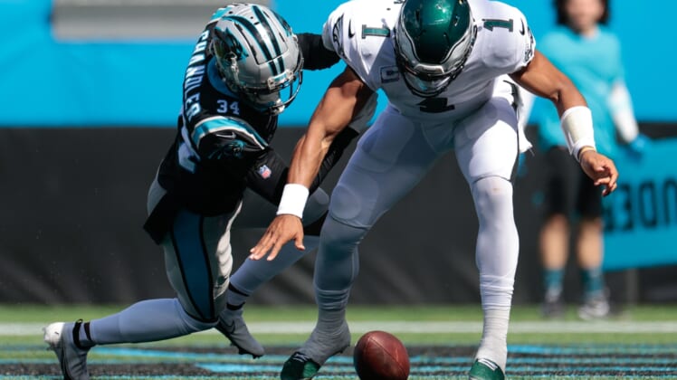 Oct 10, 2021; Charlotte, North Carolina, USA; Philadelphia Eagles quarterback Jalen Hurts (1) and Carolina Panthers defensive back Sean Chandler (34) fight for a fumble in the end zone during the first half at Bank of America Stadium. Mandatory Credit: Douglas DeFelice-USA TODAY Sports