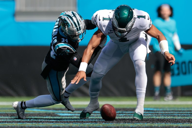 Oct 10, 2021; Charlotte, North Carolina, USA; Philadelphia Eagles quarterback Jalen Hurts (1) and Carolina Panthers defensive back Sean Chandler (34) fight for a fumble in the end zone during the first half at Bank of America Stadium. Mandatory Credit: Douglas DeFelice-USA TODAY Sports