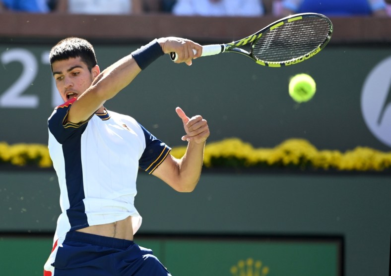 Oct 10, 2021; Indian Wells, CA, USA; Carlos Alcaraz (ESP) hits a shot during in his second round match against Andy Murray (GBR) in the BNP Paribas Open at the Indian Wells Tennis Garden. Mandatory Credit: Jayne Kamin-Oncea-USA TODAY Sports