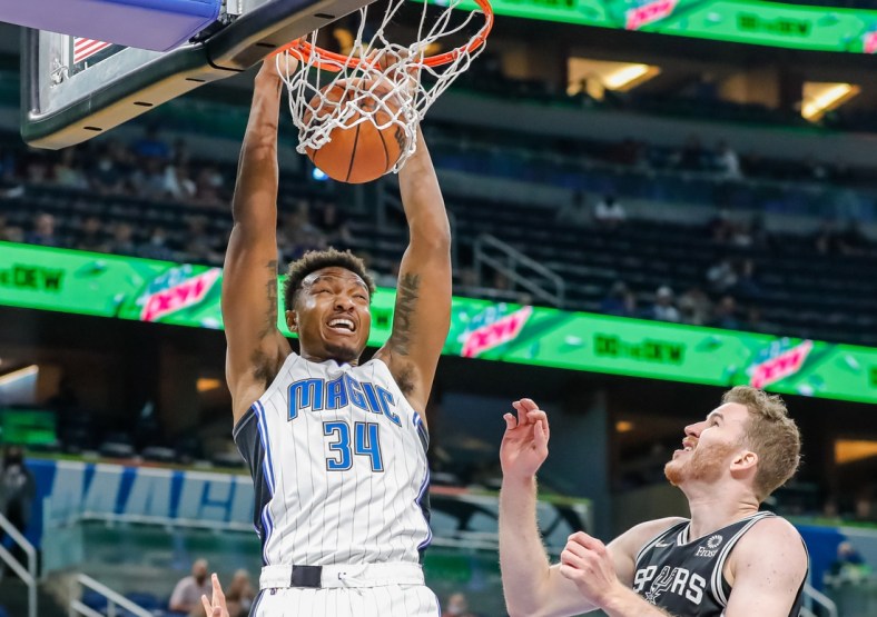 Oct 10, 2021; Orlando, Florida, USA; Orlando Magic center Wendell Carter Jr. (34) dunks the ball against San Antonio Spurs center Jakob Poeltl (25) during the first quarter against the San Antonio Spurs at Amway Center. Mandatory Credit: Mike Watters-USA TODAY Sports