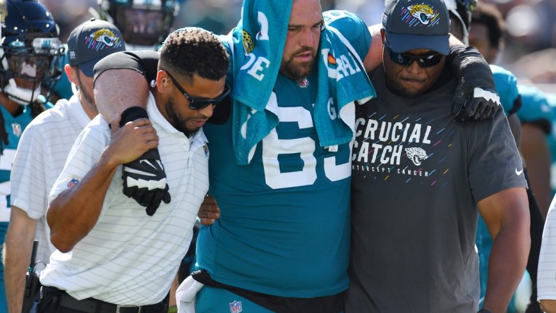 Jacksonville Jaguars center Brandon Linder (65) is assisted to a cart after he was injured during a fourth quarter play. The Jacksonville Jaguars hosted the Tennessee Titans at TIAA Bank Field in Jacksonville, Florida, October 10, 2021.  The Jaguars trailed at the half 24 to 13 and lost with a final score of 37-19. [Bob Self/Florida Times-Union]

Jki 101021 Jaguarsvstitans 35