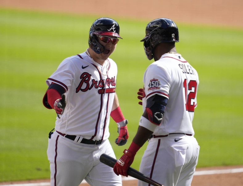 Oct 11, 2021; Cumberland, GA, USA; Atlanta Braves left fielder Joc Pederson (22) celebrates with right fielder Jorge Soler (12) after hitting a three-run home run against the Milwaukee Brewers during the fifth inning during game three of the 2021 ALDS at Truist Park. Mandatory Credit: Dale Zanine-USA TODAY Sports