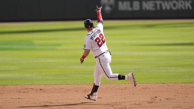 Oct 11, 2021; Cumberland, GA, USA; Atlanta Braves left fielder Joc Pederson (22) hits a three-run home run against the Milwaukee Brewers during the fifth inning during game three of the 2021 ALDS at Truist Park. Mandatory Credit: Dale Zanine-USA TODAY Sports