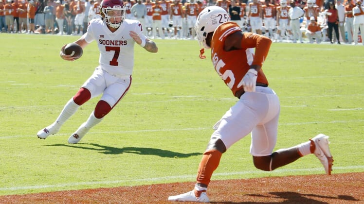 OU quarterback Spencer Rattler (7) runs for a touchdown in front of Texas' B.J. Foster (25) during the first half Saturday in Dallas.jump