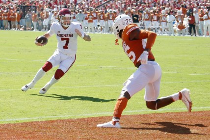 OU quarterback Spencer Rattler (7) runs for a touchdown in front of Texas' B.J. Foster (25) during the first half Saturday in Dallas.

jump