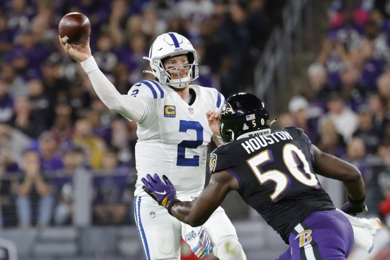Oct 11, 2021; Baltimore, Maryland, USA; Indianapolis Colts quarterback Carson Wentz (2) passes the ball under pressure from Baltimore Ravens outside linebacker Justin Houston (50) during the first quarter at M&T Bank Stadium. Mandatory Credit: Geoff Burke-USA TODAY Sports