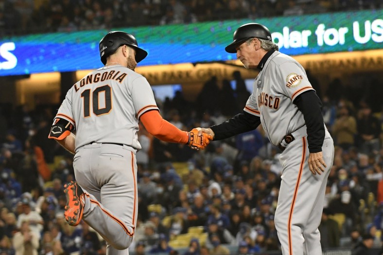 Oct 11, 2021; Los Angeles, California, USA; San Francisco Giants third baseman Evan Longoria (10) celebrates with third base coach Ron Wotus (8) after hitting a solo home run against the Los Angeles Dodgers in the fifth inning during game three of the 2021 NLDS at Dodger Stadium. Mandatory Credit: Richard Mackson-USA TODAY Sports