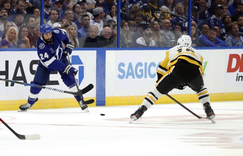 Oct 12, 2021; Tampa, Florida, USA; Tampa Bay Lightning defenseman Zach Bogosian (24) passes the puck against Pittsburgh Penguins center Sam Lafferty (18) during the first period at Amalie Arena. Mandatory Credit: Kim Klement-USA TODAY Sports