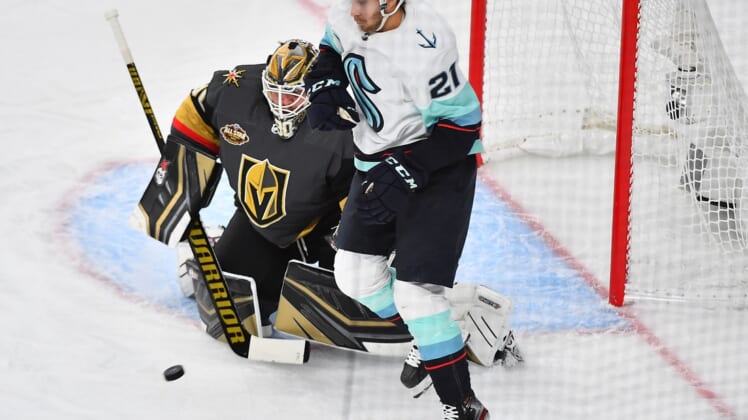 Oct 12, 2021; Las Vegas, Nevada, USA; Vegas Golden Knights goaltender Robin Lehner (90) protects his net as Seattle Kraken center Alex Wennberg (21) waits to deflect an incoming shot during the first period at T-Mobile Arena. Mandatory Credit: Stephen R. Sylvanie-USA TODAY Sports