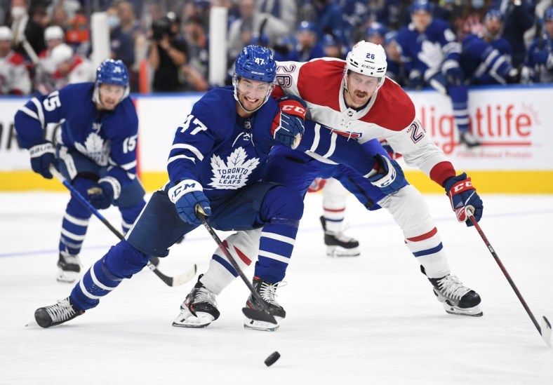 Oct 13, 2021; Toronto, Ontario, CAN;   Toronto Maple Leafs forward Pierre Engvall (47) pursues the puck ahead of Montreal Canadiens defenseman Jeff Petry (26) n the second period at Scotiabank Arena. Mandatory Credit: Dan Hamilton-USA TODAY Sports