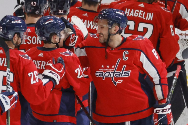 Oct 13, 2021; Washington, District of Columbia, USA; Washington Capitals left wing Alex Ovechkin (8) celebrates with Capitals center Hendrix Lapierre (29) after their game against the New York Rangers at Capital One Arena. Mandatory Credit: Geoff Burke-USA TODAY Sports