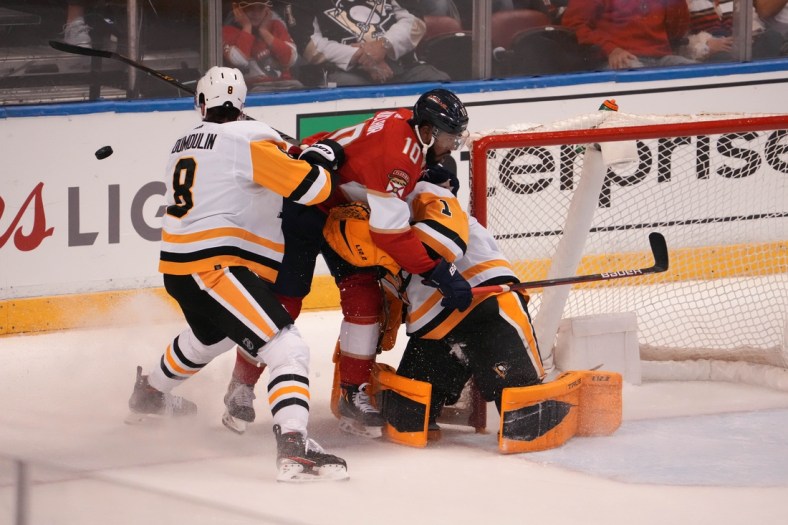 Oct 14, 2021; Sunrise, Florida, USA; Florida Panthers left wing Anthony Duclair (10) crashes into Pittsburgh Penguins goaltender Casey DeSmith (1) on the interference penalty of defenseman Brian Dumoulin (8)  during the first period at FLA Live Arena. Mandatory Credit: Jasen Vinlove-USA TODAY Sports