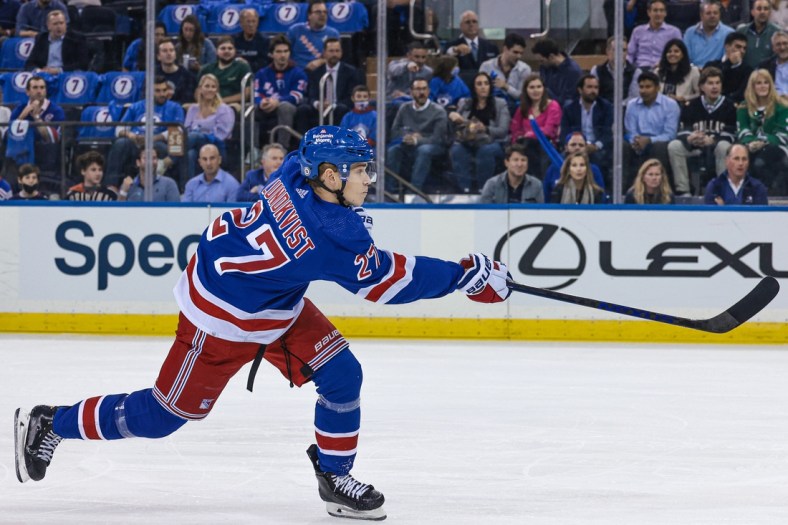 Oct 14, 2021; New York, New York, USA; New York Rangers defenseman Nils Lundkvist (27) shoots the puck against the Dallas Stars during the first period at Madison Square Garden. Mandatory Credit: Vincent Carchietta-USA TODAY Sports