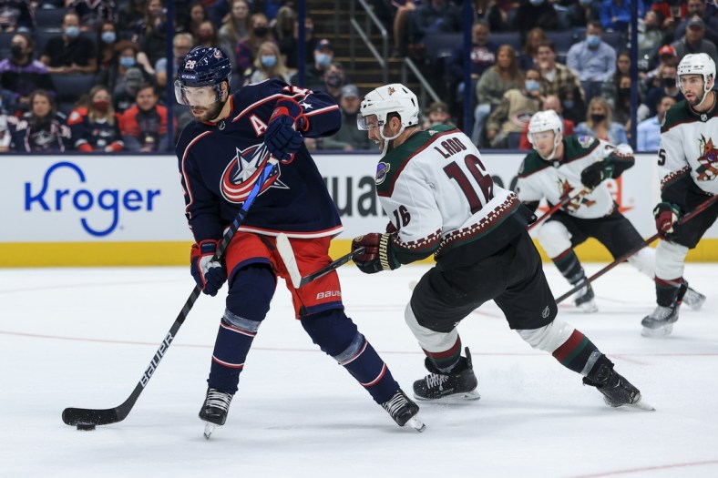 Oct 14, 2021; Columbus, Ohio, USA; Columbus Blue Jackets right wing Oliver Bjorkstrand (28) skates against Arizona Coyotes left wing Andrew Ladd (16) in the first period at Nationwide Arena. Mandatory Credit: Aaron Doster-USA TODAY Sports