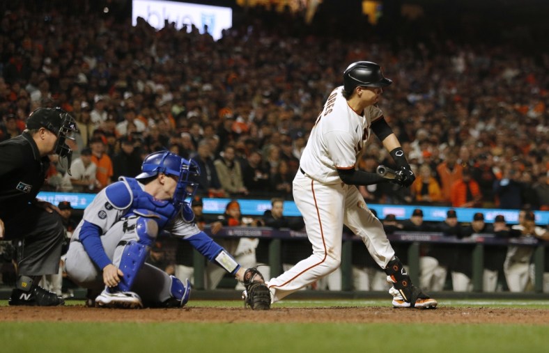 Oct 14, 2021; San Francisco, California, USA; San Francisco Giants first baseman Wilmer Flores (41) tries to check his swing against the Los Angeles Dodgers in the ninth inning during game five of the 2021 NLDS at Oracle Park. First base umpire Gabe Morales (47) ruled Flores swung for strike three to end the game. Mandatory Credit: D. Ross Cameron-USA TODAY Sports