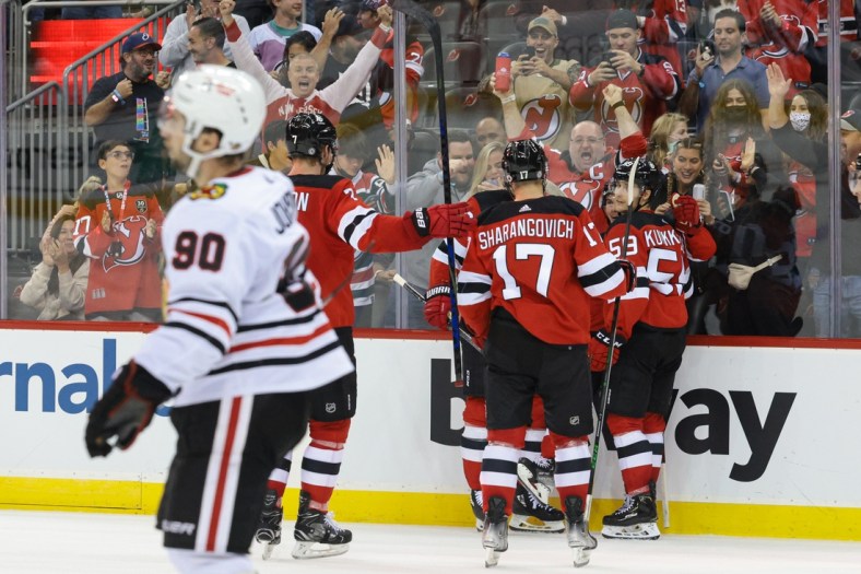 Oct 15, 2021; Newark, New Jersey, USA; New Jersey Devils center Jack Hughes (86) celebrates his goal with teammates during the second period against the Chicago Blackhawks at Prudential Center. Mandatory Credit: Vincent Carchietta-USA TODAY Sports