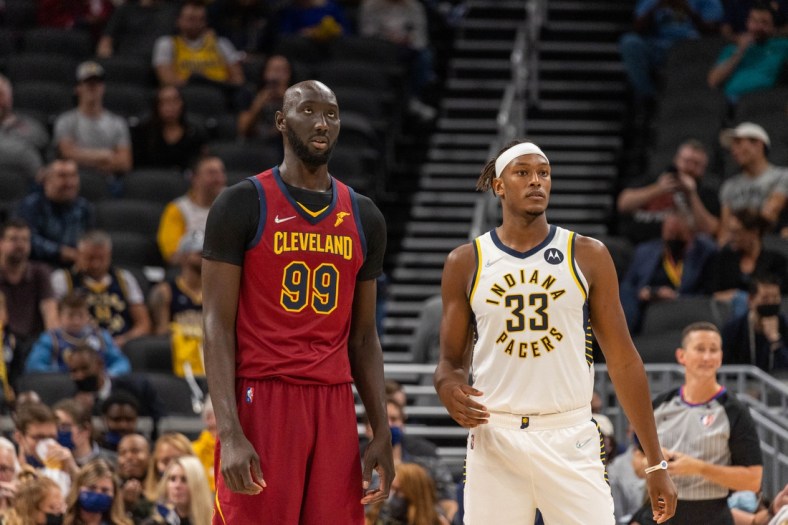 Oct 15, 2021; Indianapolis, Indiana, USA; Cleveland Cavaliers center Tacko Fall (99) and Indiana Pacers center Myles Turner (33) during a timeout in the second half at Gainbridge Fieldhouse. Mandatory Credit: Trevor Ruszkowski-USA TODAY Sports
