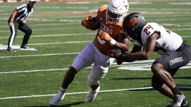 Oct 16, 2021; Austin, Texas, USA; Texas Longhorns running back Bijan Robinson (5) runs for yardage in the red zone in the first half of the game against the Oklahoma State Cowboys at Darrell K Royal-Texas Memorial Stadium. Mandatory Credit: Scott Wachter-USA TODAY Sports