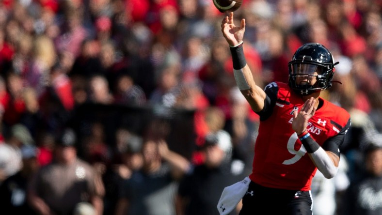 Cincinnati Bearcats quarterback Desmond Ridder (9) throws for a first down to Cincinnati Bearcats wide receiver Tyler Scott (21) in the first half of the NCAA football game between the Cincinnati Bearcats and the UCF Knights on Saturday, Oct. 15, 2021, at Nippert Stadium in Cincinnati.

Ucf Knights At Cincinnati Bearcats 141