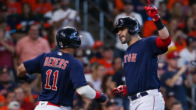 Oct 16, 2021; Houston, Texas, USA; Boston Red Sox designated hitter J.D. Martinez (28) is congratulated by third baseman Rafael Devers (11) after hitting a grand slam against the Houston Astros during the first inning in game two of the 2021 ALCS at Minute Maid Park. Mandatory Credit: Troy Taormina-USA TODAY Sports