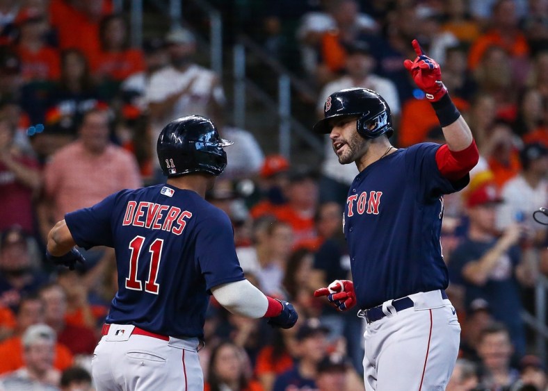 Oct 16, 2021; Houston, Texas, USA; Boston Red Sox designated hitter J.D. Martinez (28) is congratulated by third baseman Rafael Devers (11) after hitting a grand slam against the Houston Astros during the first inning in game two of the 2021 ALCS at Minute Maid Park. Mandatory Credit: Troy Taormina-USA TODAY Sports