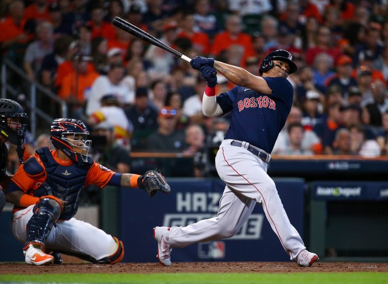 Oct 16, 2021; Houston, Texas, USA; Boston Red Sox third baseman Rafael Devers (11) hits a grand slam against the Houston Astros during the second inning in game two of the 2021 ALCS at Minute Maid Park. Mandatory Credit: Troy Taormina-USA TODAY Sports