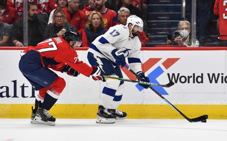Oct 16, 2021; Washington, District of Columbia, USA; Tampa Bay Lightning left wing Alex Killorn (17) carries the puck as Washington Capitals right wing T.J. Oshie (77) defends during the first period at Capital One Arena. Mandatory Credit: Brad Mills-USA TODAY Sports