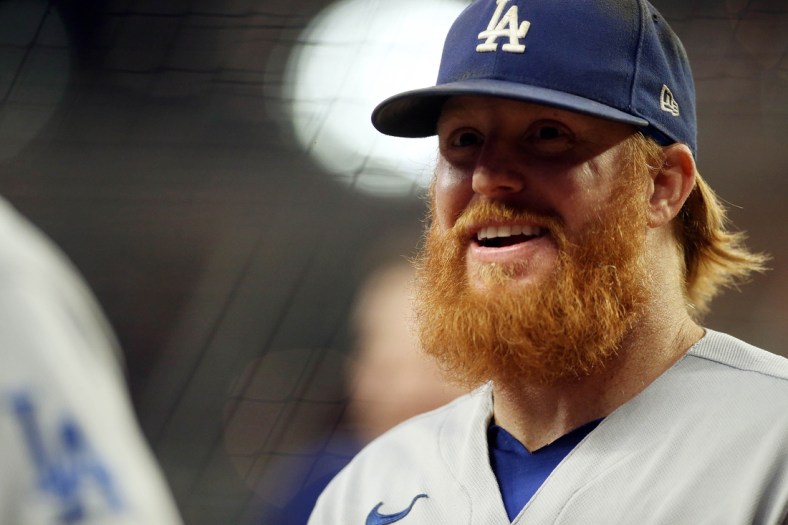 Oct 16, 2021; Cumberland, Georgia, USA; Los Angeles Dodgers third baseman Justin Turner (10) smiles as he walks off the field  before game one of the 2021 NLCS against the Atlanta Braves at Truist Park. Mandatory Credit: Brett Davis-USA TODAY Sports