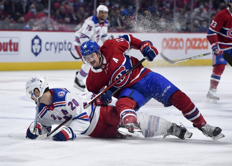 Oct 16, 2021; Montreal, Quebec, CAN; Montreal Canadiens defenseman Jeff Petry (26) falls on top of New York Rangers forward Chris Kreider (20) during the first period at the Bell Centre. Mandatory Credit: Eric Bolte-USA TODAY Sports