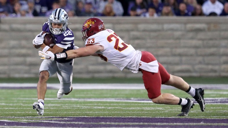 Oct 16, 2021; Manhattan, Kansas, USA; Kansas State Wildcats running back Deuce Vaughn (22) runs against Iowa State Cyclones linebacker Mike Rose (23) during the first quarter at Bill Snyder Family Football Stadium. Mandatory Credit: Scott Sewell-USA TODAY Sports