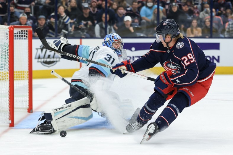 Oct 16, 2021; Columbus, Ohio, USA; Columbus Blue Jackets right wing Patrik Laine (29) attempts a shot as Seattle Kraken goaltender Philipp Grubauer (31) makes a save in net in the second period at Nationwide Arena. Mandatory Credit: Aaron Doster-USA TODAY Sports