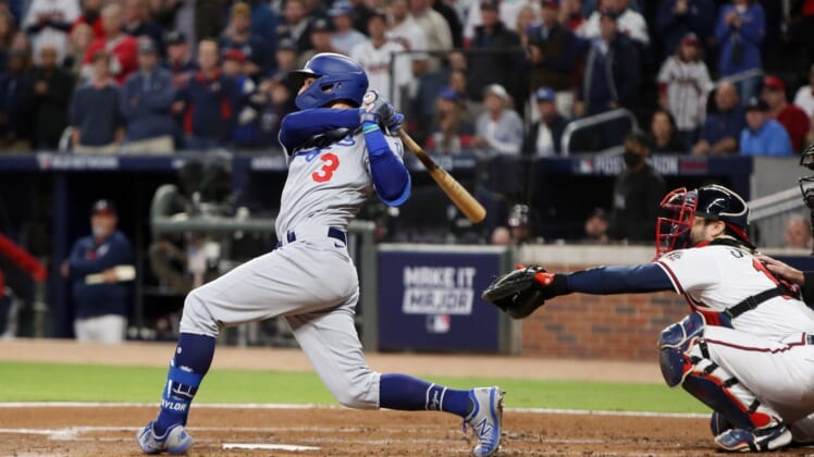 Oct 16, 2021; Cumberland, Georgia, USA; Los Angeles Dodgers left fielder Chris Taylor (3) hits an RBI single against the Atlanta Braves during the second inning in game one of the 2021 NLCS at Truist Park. Mandatory Credit: Brett Davis-USA TODAY Sports