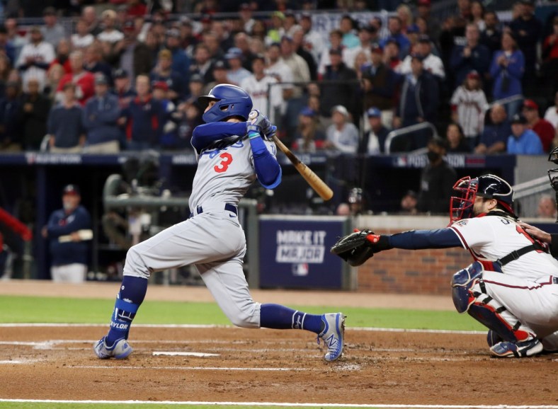 Oct 16, 2021; Cumberland, Georgia, USA; Los Angeles Dodgers left fielder Chris Taylor (3) hits an RBI single against the Atlanta Braves during the second inning in game one of the 2021 NLCS at Truist Park. Mandatory Credit: Brett Davis-USA TODAY Sports