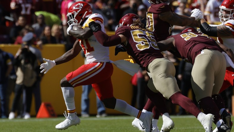 Oct 17, 2021; Landover, Maryland, USA; Kansas City Chiefs running back Darrel Williams (31) carries the ball as Washington Football Team linebacker Cole Holcomb (55) defends during the first quarter at FedExField. Mandatory Credit: Geoff Burke-USA TODAY Sports