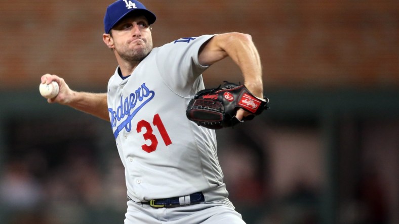 Oct 17, 2021; Cumberland, Georgia, USA; Los Angeles Dodgers starting pitcher Max Scherzer (31) pitching against the Atlanta Braves during the first inning in game two of the 2021 NLCS at Truist Park. Mandatory Credit: Brett Davis-USA TODAY Sports