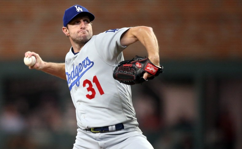 Oct 17, 2021; Cumberland, Georgia, USA; Los Angeles Dodgers starting pitcher Max Scherzer (31) pitching against the Atlanta Braves during the first inning in game two of the 2021 NLCS at Truist Park. Mandatory Credit: Brett Davis-USA TODAY Sports