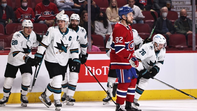 Oct 19, 2021; Montreal, Quebec, CAN; San Jose Sharks center Jonathan Dhalen (76) (left) celebrates his goal against the Montreal Canadiens with teammates during the first period as left wing Jonathan Drouin (92) passes on at Bell Centre. Mandatory Credit: Jean-Yves Ahern-USA TODAY Sports