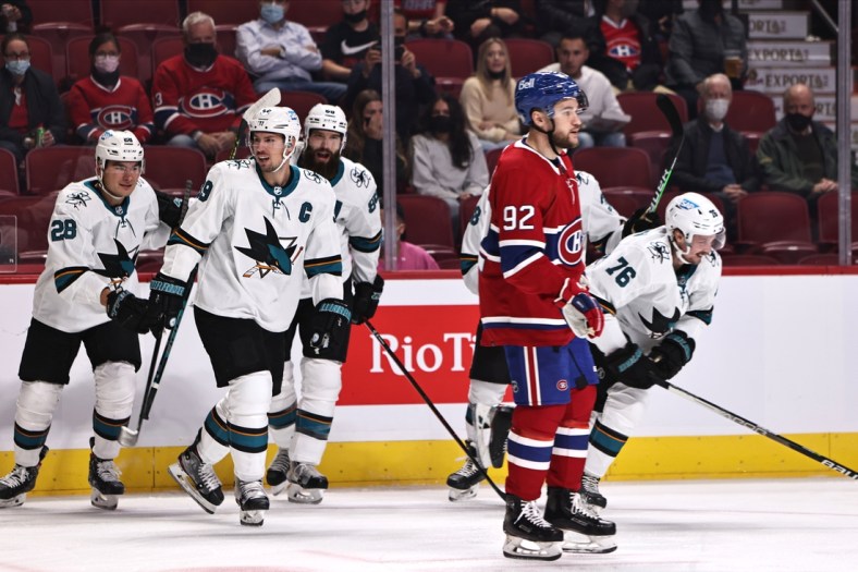 Oct 19, 2021; Montreal, Quebec, CAN; San Jose Sharks center Jonathan Dhalen (76) (left) celebrates his goal against the Montreal Canadiens with teammates during the first period as left wing Jonathan Drouin (92) passes on at Bell Centre. Mandatory Credit: Jean-Yves Ahern-USA TODAY Sports