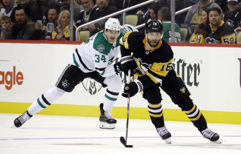 Oct 19, 2021; Pittsburgh, Pennsylvania, USA;  Pittsburgh Penguins left wing Jason Zucker (16) sites up ice with the puck ahead of Dallas Stars right wing Denis Gurianov (34) during the second period at PPG Paints Arena. Mandatory Credit: Charles LeClaire-USA TODAY Sports