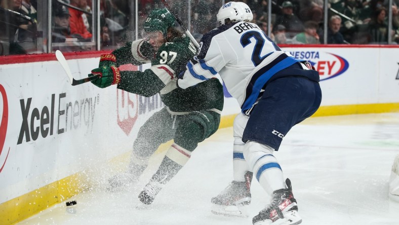 Oct 19, 2021; Saint Paul, Minnesota, USA; Minnesota Wild left wing Kirill Kaprizov (97) is checked by Winnipeg Jets defenseman Nathan Beaulieu (28) in the second period at Xcel Energy Center. Mandatory Credit: David Berding-USA TODAY Sports