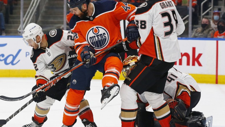 Oct 19, 2021; Edmonton, Alberta, CAN; Edmonton Oilers forward Zack Kassian (44) battles for a loose puck with Anaheim Ducks forward Derek Grant (38) and defensemen Kevin Shattenkirk (22)  during the first period at Rogers Place. Mandatory Credit: Perry Nelson-USA TODAY Sports