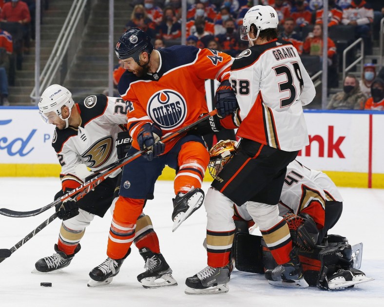 Oct 19, 2021; Edmonton, Alberta, CAN; Edmonton Oilers forward Zack Kassian (44) battles for a loose puck with Anaheim Ducks forward Derek Grant (38) and defensemen Kevin Shattenkirk (22)  during the first period at Rogers Place. Mandatory Credit: Perry Nelson-USA TODAY Sports