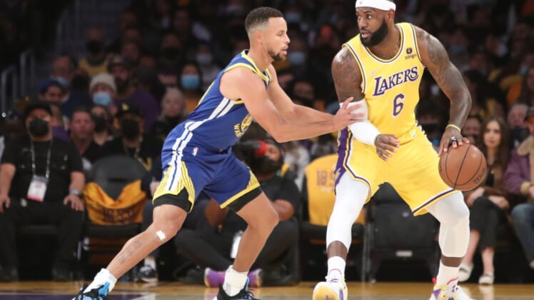 Oct 19, 2021; Los Angeles, California, USA; Los Angeles Lakers forward LeBron James (6) dribbles a ball against Golden State Warriors guard Stephen Curry (30) during the first quarter at Staples Center. Mandatory Credit: Kiyoshi Mio-USA TODAY Sports