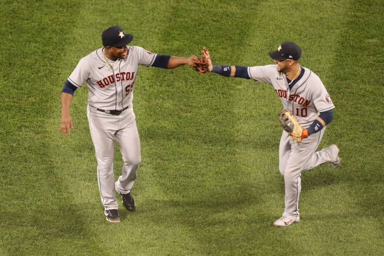 Oct 20, 2021; Boston, Massachusetts, USA; Houston Astros starting pitcher Framber Valdez (59) and first baseman Yuli Gurriel (10) react after the last out of the seventh inning of game five of the 2021 ALCS at Fenway Park. Mandatory Credit: Paul Rutherford-USA TODAY Sports