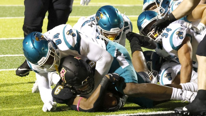 Oct 20, 2021; Boone, North Carolina, USA; Coastal Carolina Chanticleers linebacker Jeffrey Gunter (94) stops Appalachian State Mountaineers running back Camerun Peoples (6) at the one yard line during the second quarter at Kidd Brewer Stadium. Mandatory Credit: Reinhold Matay-USA TODAY Sports